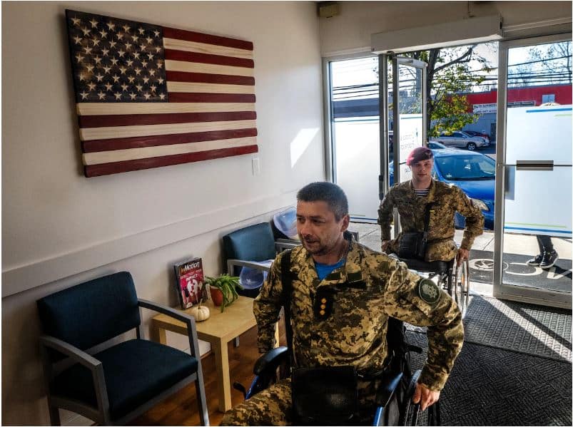 Tyshchenko, foreground, and Fedun arrive at Medical Center Orthotics and Prosthetics in Silver Spring, Md. to receive replacement limbs. (Bill O'Leary/The Washington Post)