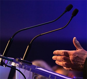 hands at a podium