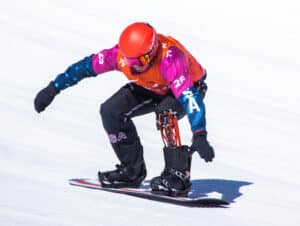 Mike Schultz balances on his snowboard down a hill.