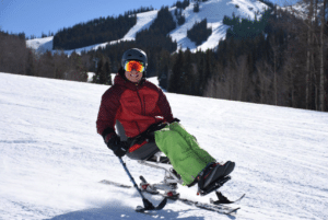 Man on sit ski sitting on a snowy white mountain